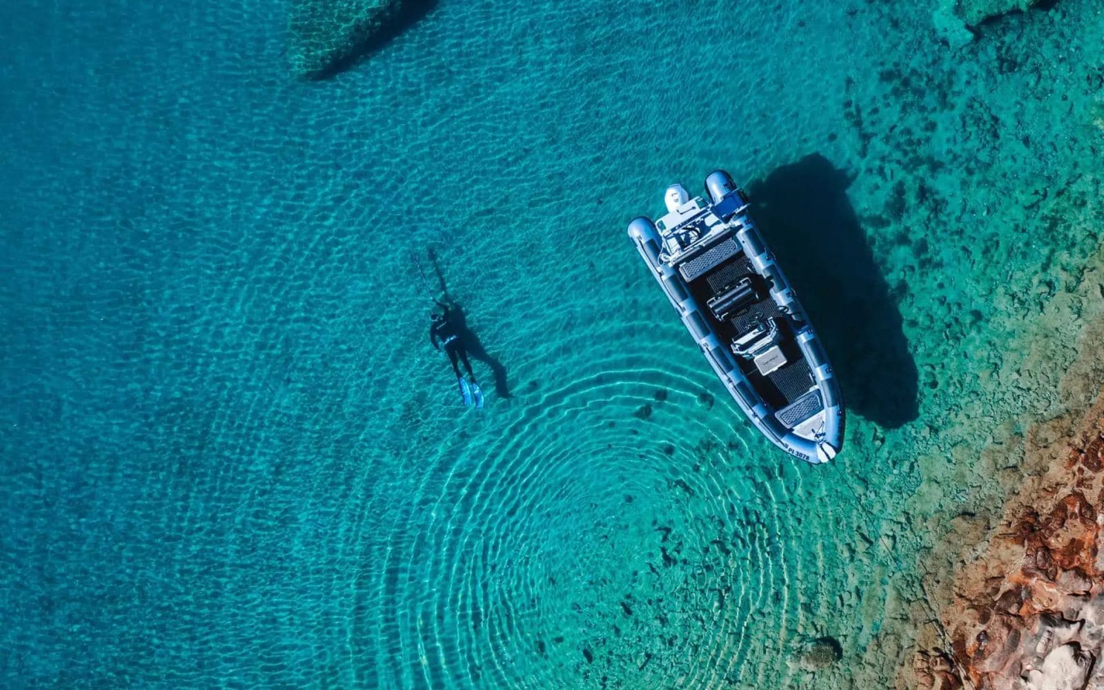 A Highfield RIB anchored over clear water, seen from above