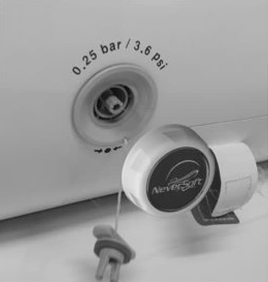 The valve uncovered, with a Neversoft cap held beside it.